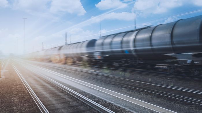 A train of tank wagons speeds past 