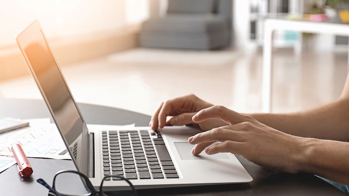 Applicant typing on a laptop.