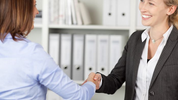 HR manager shaking hands with an applicant.