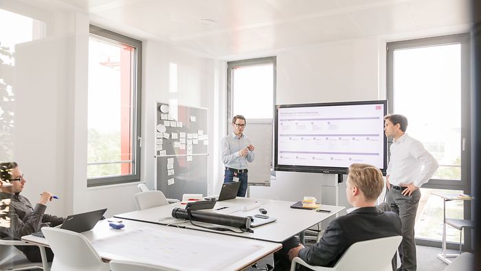 Four employees in a project meeting