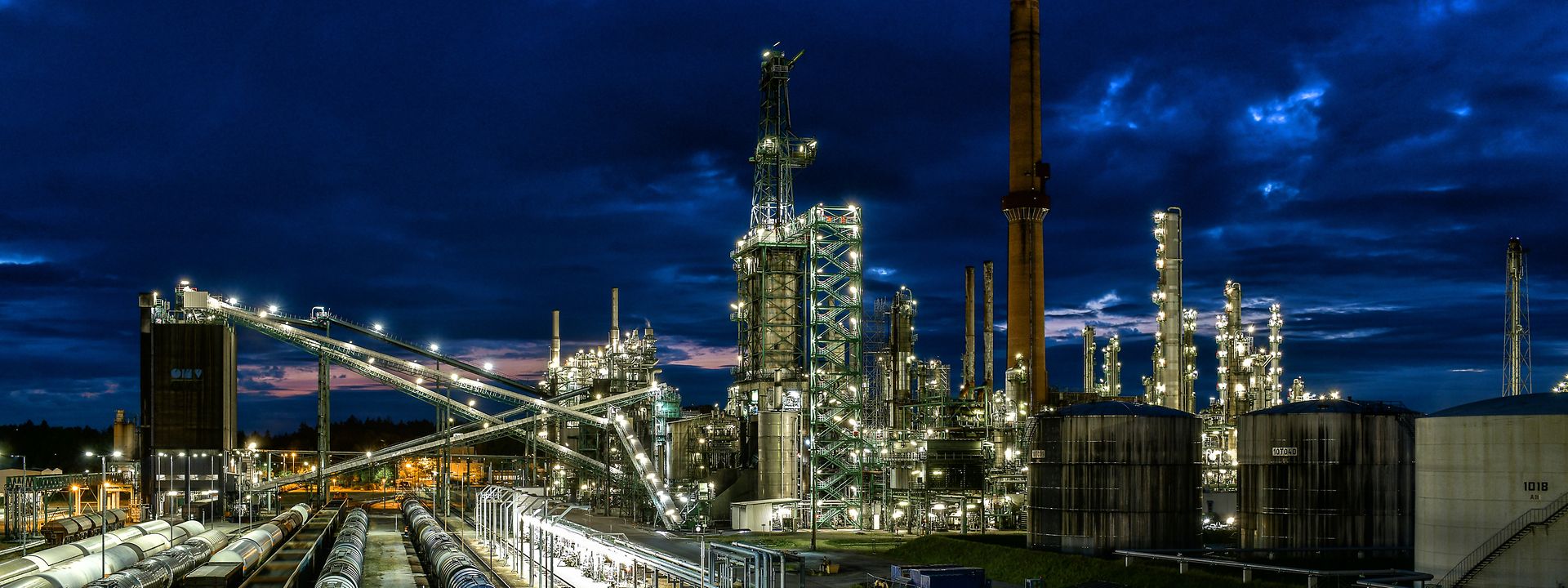Refinery and rail tracks by night