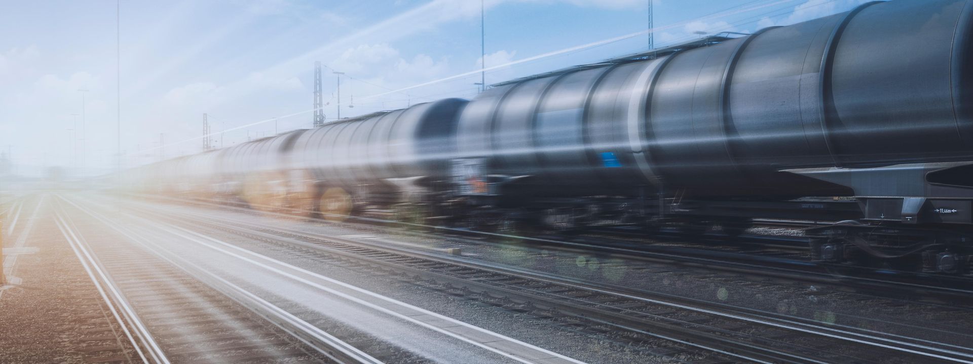 A train of tank wagons speeds past 