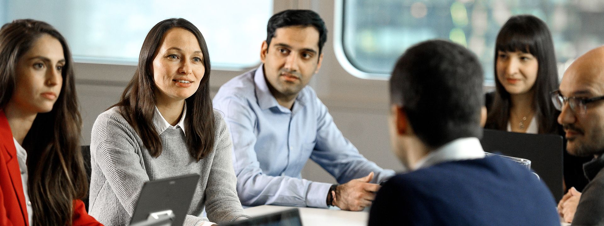 Employees at a meeting table